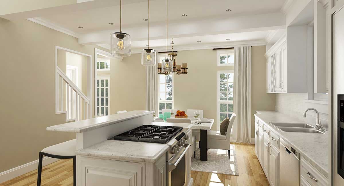 Kitchen and dining area with island gas range, white cabinetry, dining table, and staircase visible.