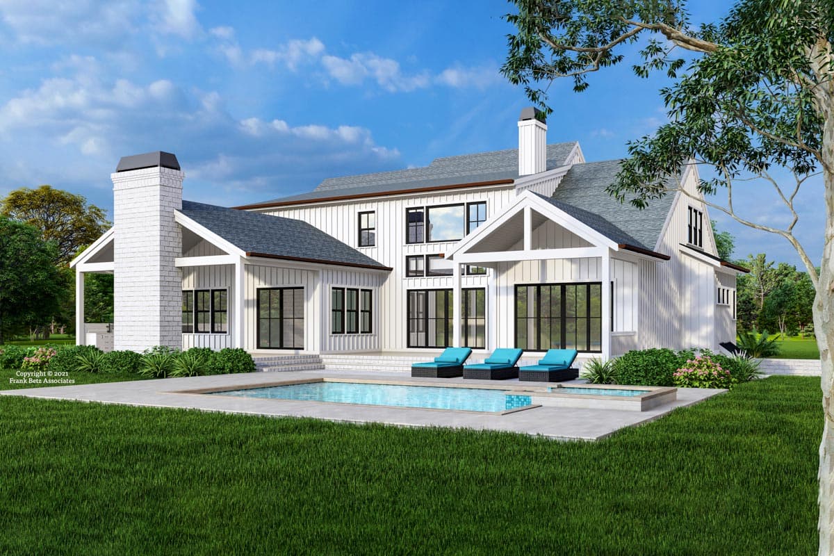 Modern Farmhouse house plan exterior with white board-and-batten siding, large windows, gables, and a prominent brick chimney.