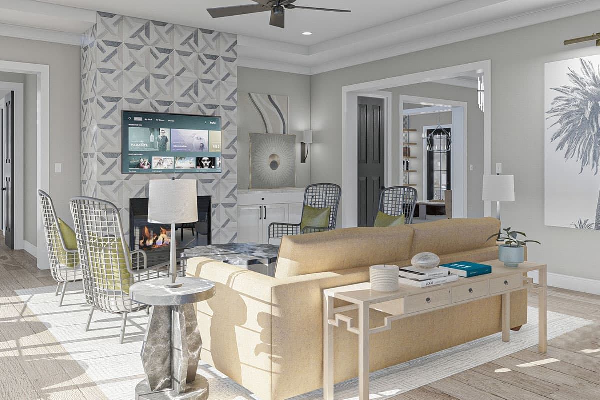 Living room interior with fireplace, television, sofa, console table, and open doorway to dining area.