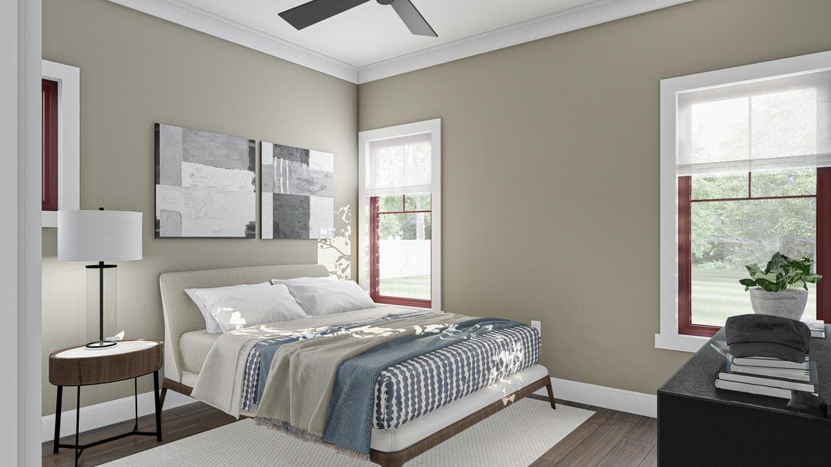 Bedroom interior with a bed, nightstand, and two windows. Artwork above the bed. Ceiling fan.