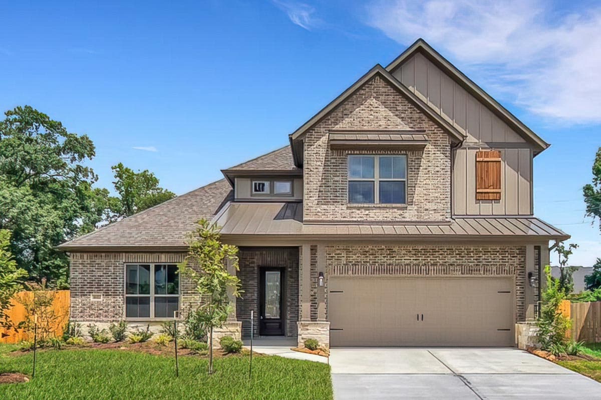 Two-story house plan exterior with gabled roof, brick facade, and attached garage. Includes decorative shutters and covered entryway.