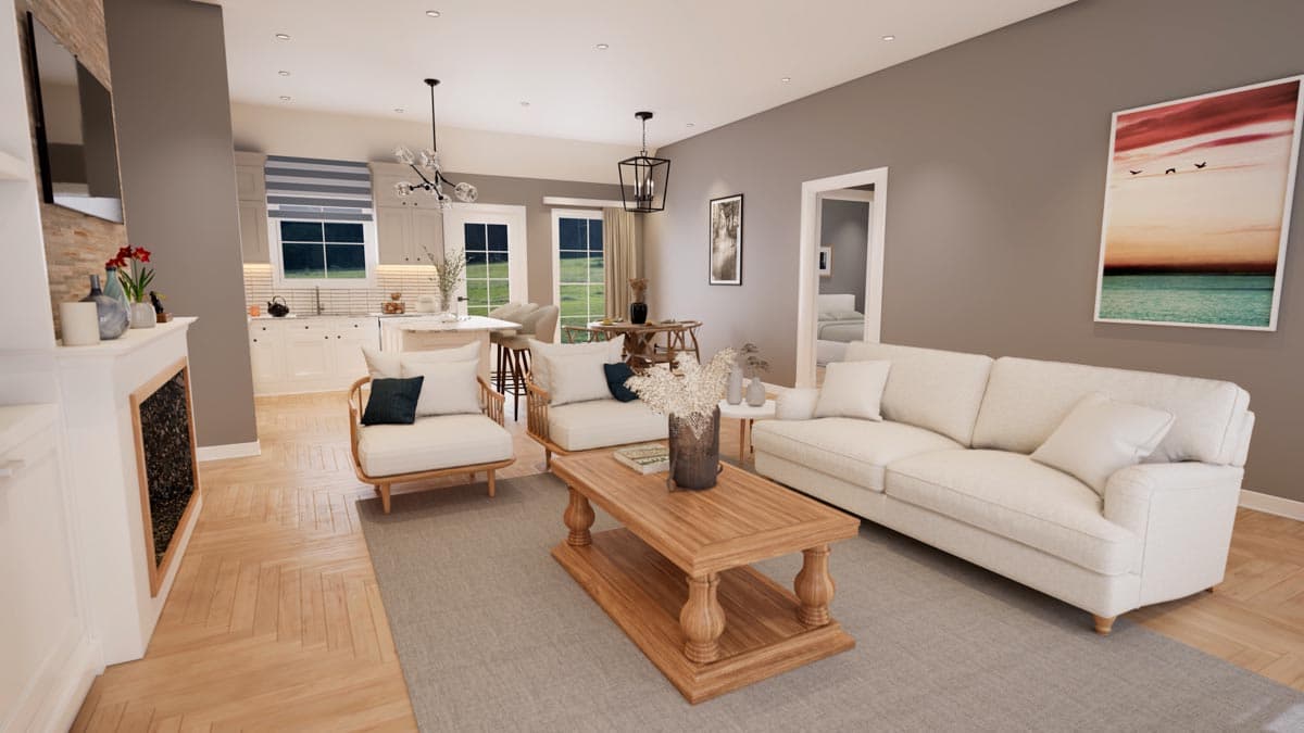 Living room with fireplace, sofas, coffee table, and kitchen with island visible. Open layout.