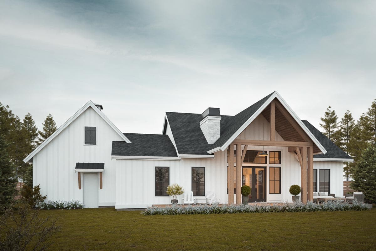 Modern Farmhouse house plan exterior with white board-and-batten siding, gables, prominent chimney, and timber frame entrance.