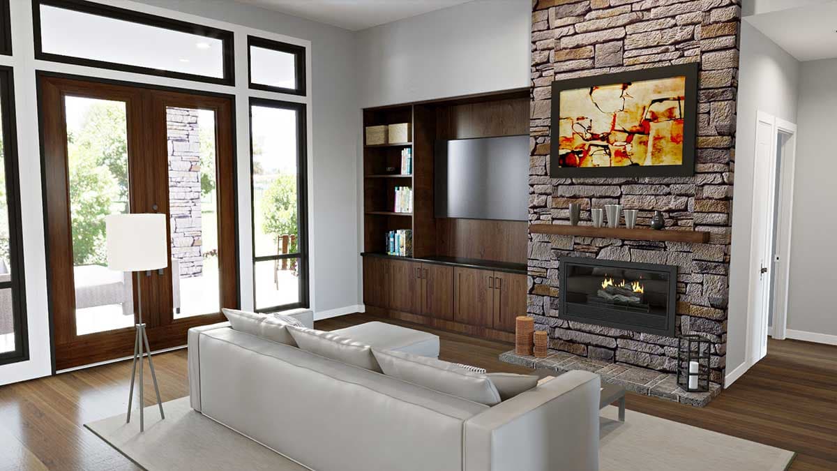 Living room with stone fireplace, built-in media center with wood cabinetry, and French doors with transom windows.