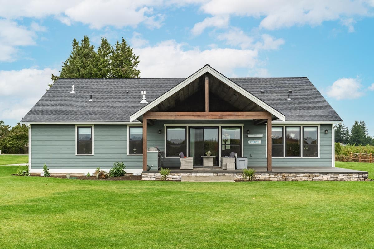 House plan exterior: Ranch style, one story, with a covered porch featuring exposed wood beams and stone accents.