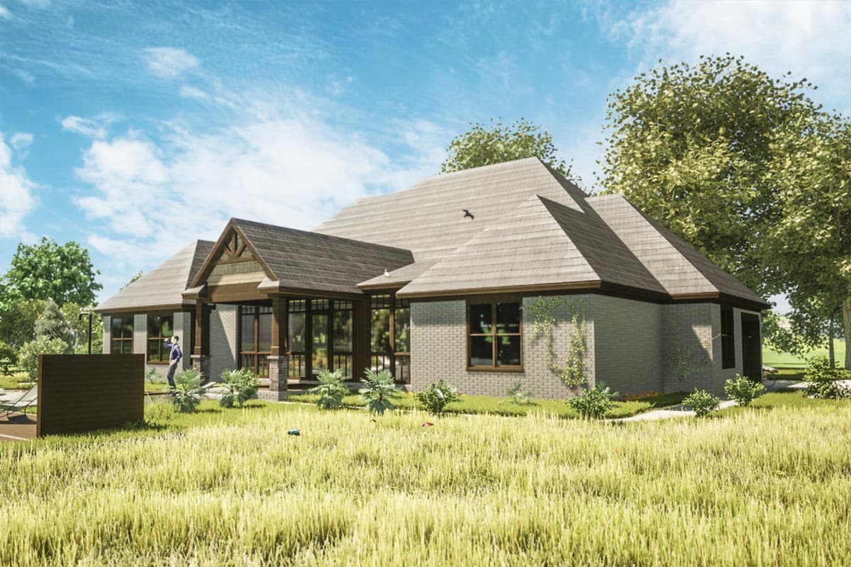 House plan exterior rendering of a single-story home with a covered porch, gables, and brick facade.