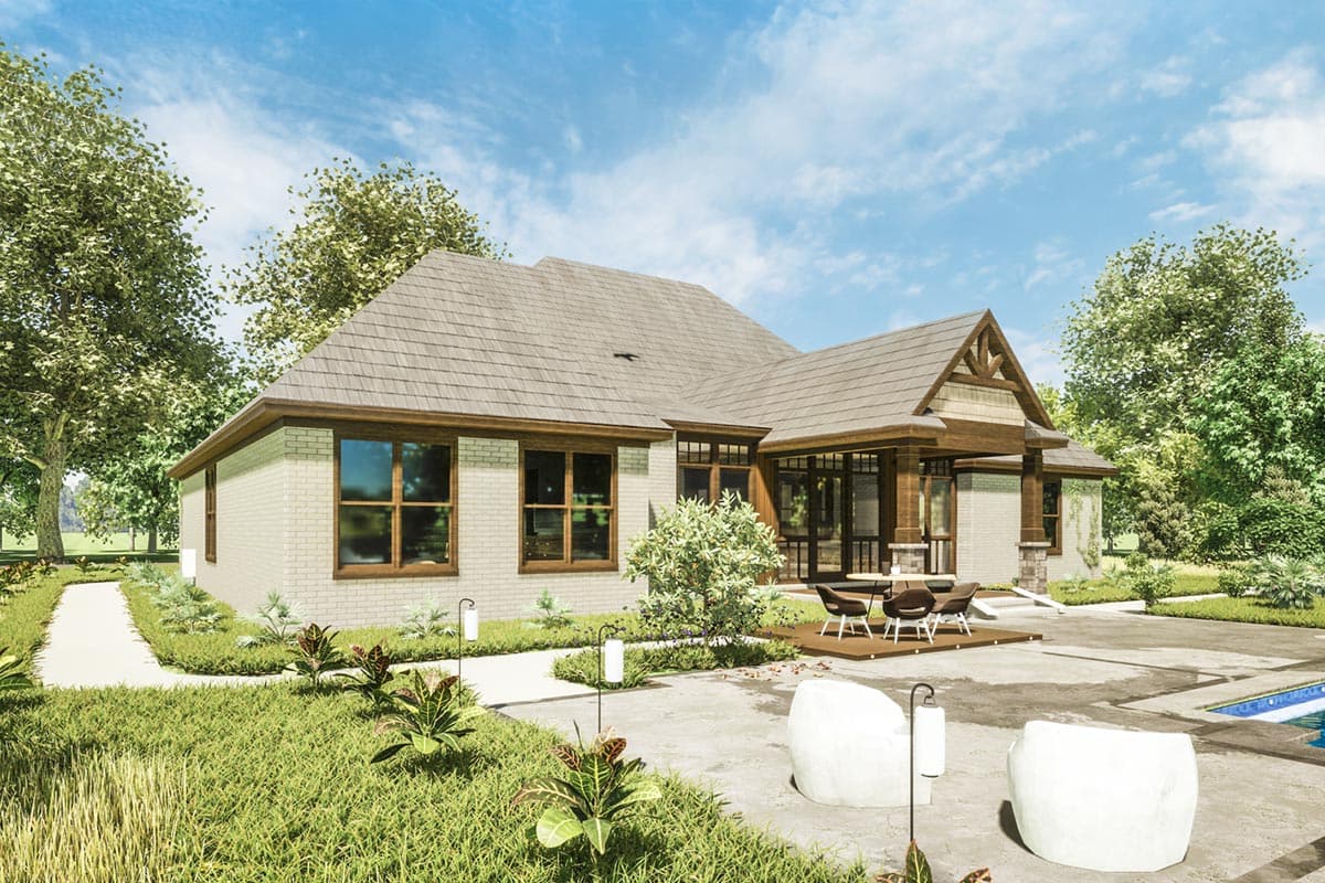 House plan exterior featuring brick facade, multiple gables, a covered porch with wood columns, and a shingled roof.
