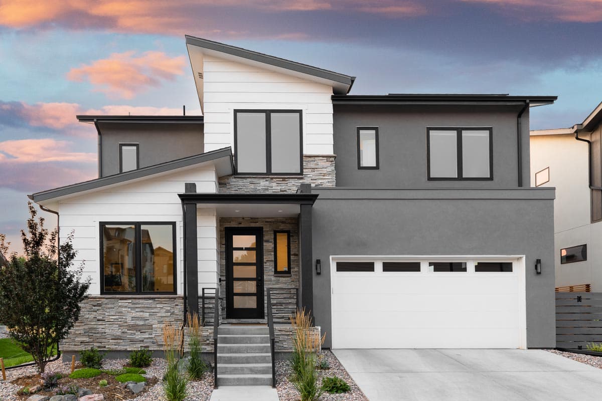 House plan exterior with modern design. Features include a two-story structure, a flat roof, stone accents, and a front-entry garage.