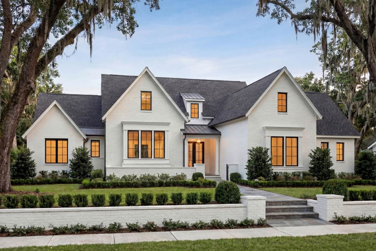 Modern Farmhouse style house plan exterior with white brick, multiple gables, dormer, and black-framed windows.