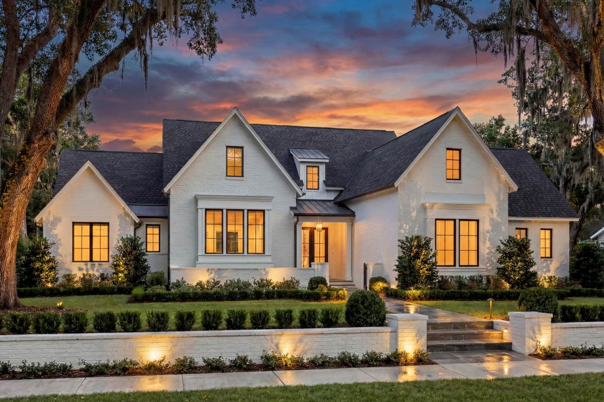 Modern Farmhouse house plan exterior with white brick, gables, dormer, and covered entry.