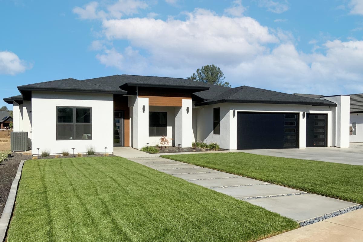 House plan exterior featuring a contemporary style, single-story, with flat roof, attached garage, and a covered entryway.