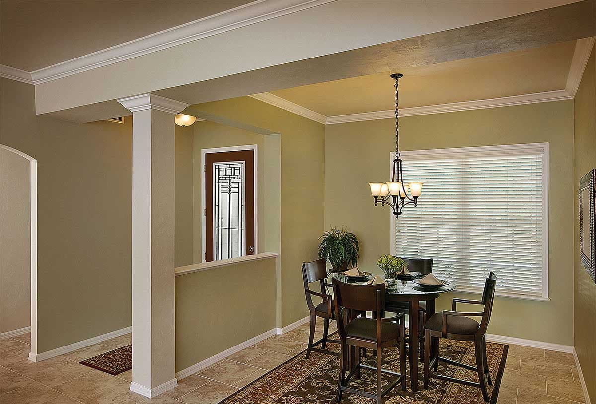 Dining area with glass-paneled door, chandelier, and window with blinds.