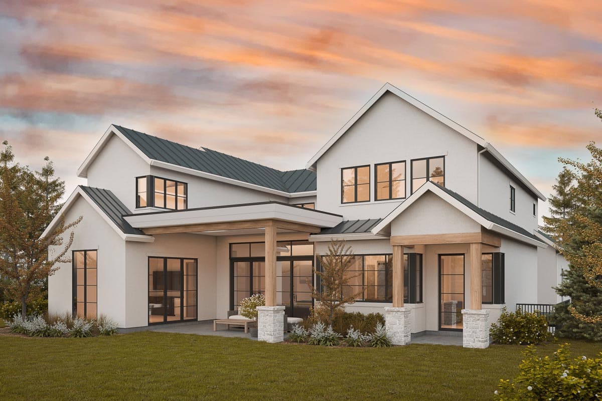 Modern Farmhouse house plan exterior with gables, dark metal roof, large windows, and covered porch with stone-clad columns.