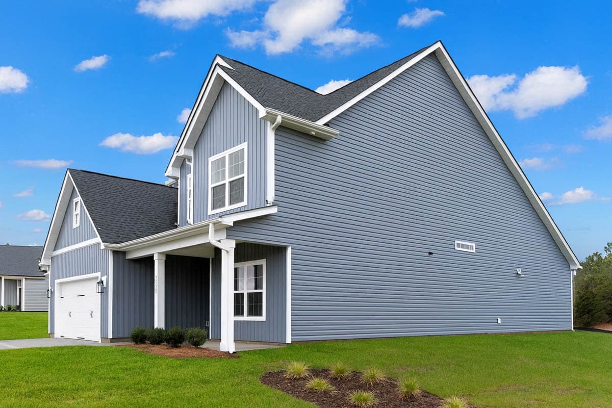 House plan exterior, two stories, siding, gabled roof, covered porch, and attached garage.
