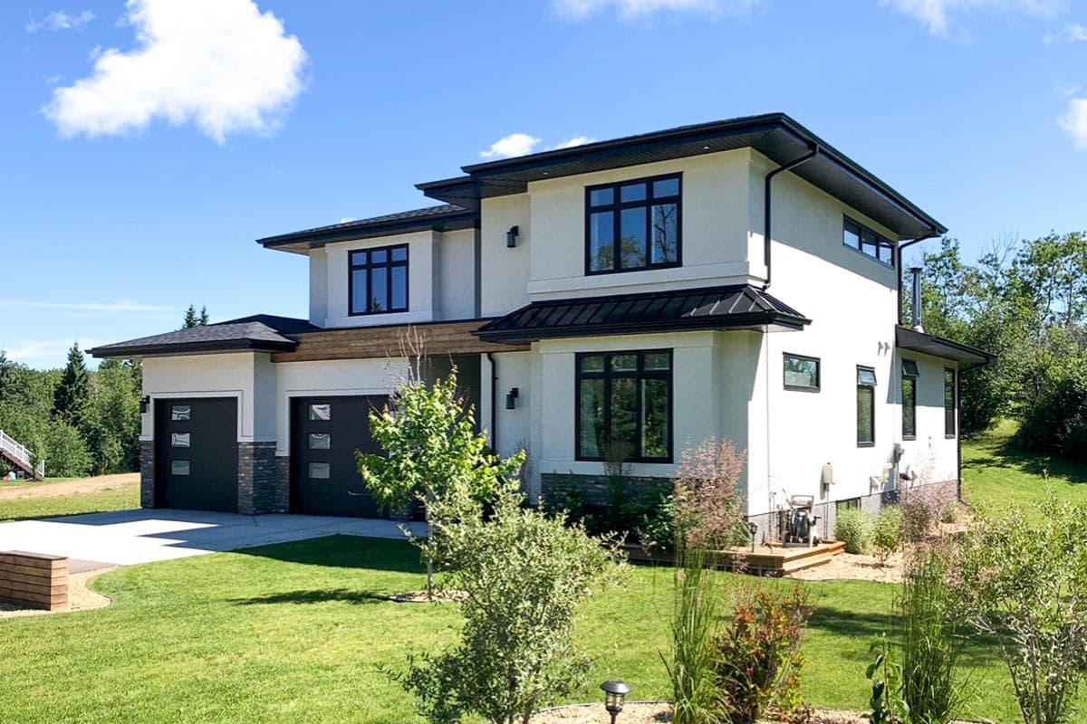 Modern two-story house plan exterior with stucco, flat rooflines, large black-framed windows, and a three-car garage.