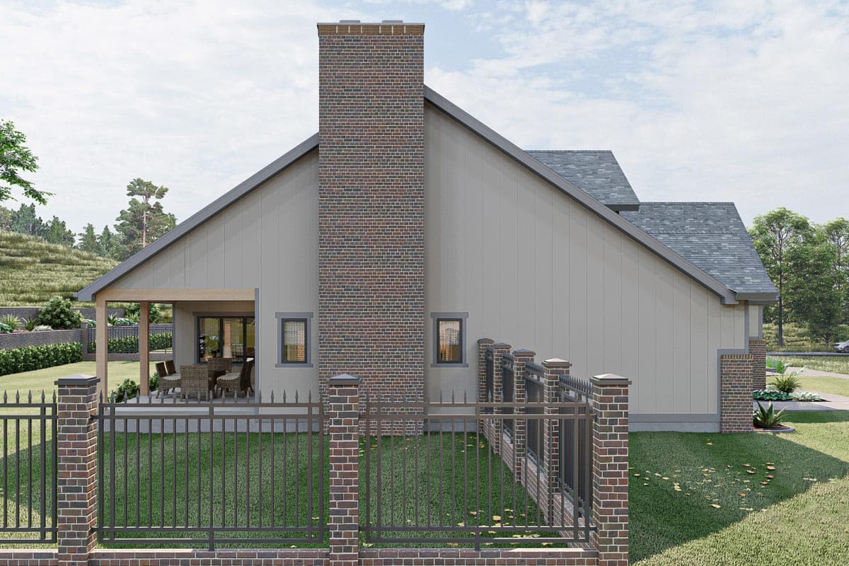 House plan exterior with large brick chimney, covered patio, and metal fence. Modern style.