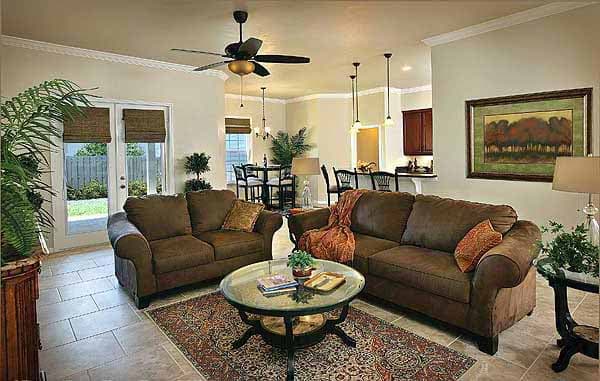 Living room with two sofas, coffee table, and view to dining area and kitchen.
