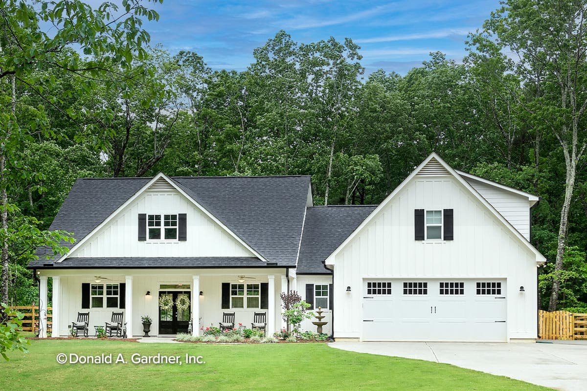 Modern Farmhouse house plan exterior with wide porch, gables, dormers, and a two-car garage.