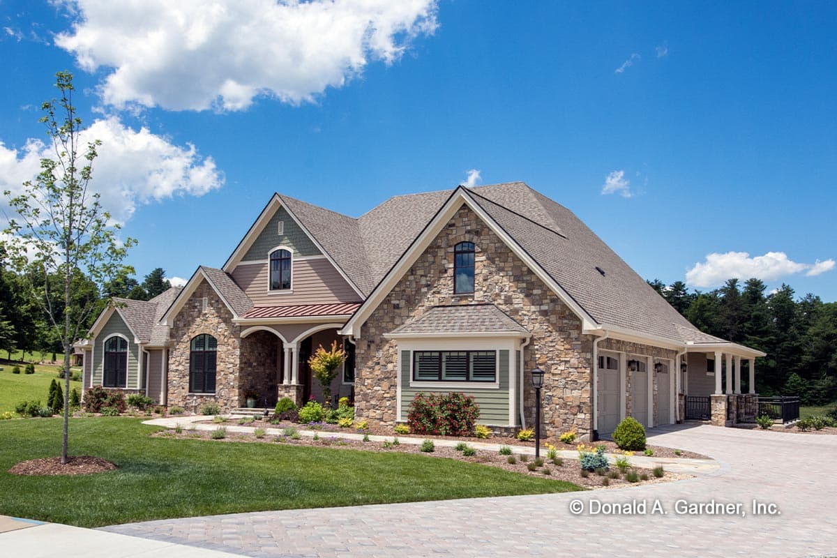 House plan exterior: Modern Farmhouse style, 2 stories, stone and siding, arched entry, multiple gables, triple garage.