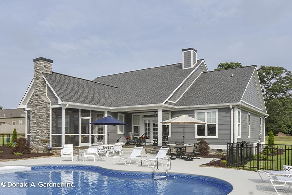 House plan exterior: Ranch style with stone chimney, screened porch, and a swimming pool.