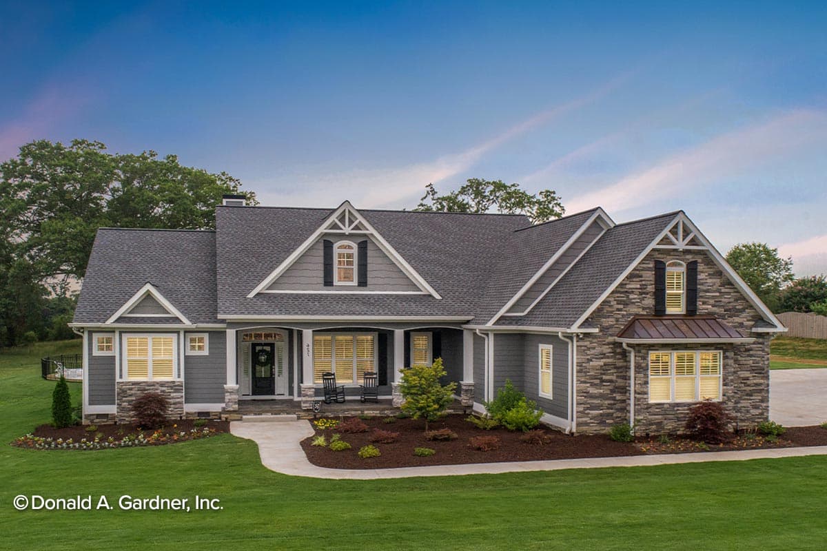 House plan exterior: Ranch-style home with stone accents, covered front porch, gables, and dormers.