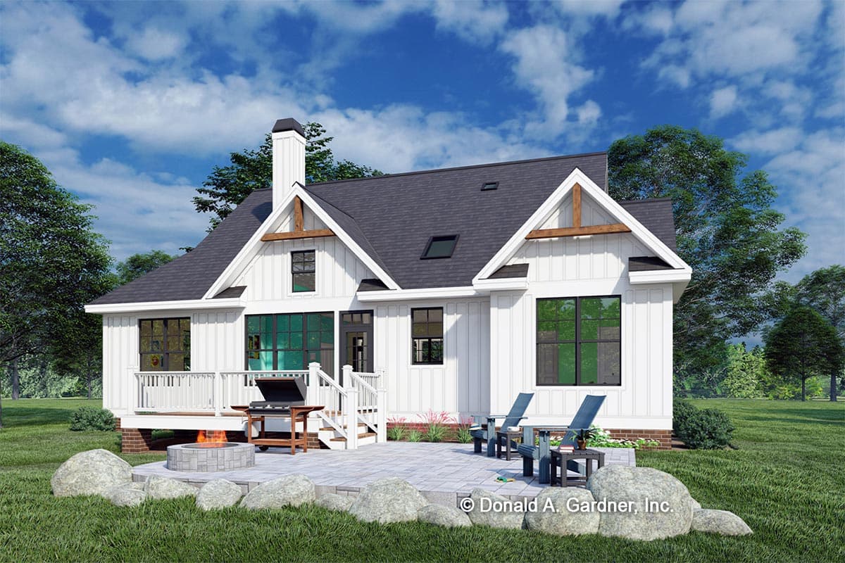 Modern Farmhouse house plan exterior with white board-and-batten siding, gables, prominent chimney, and rear deck.