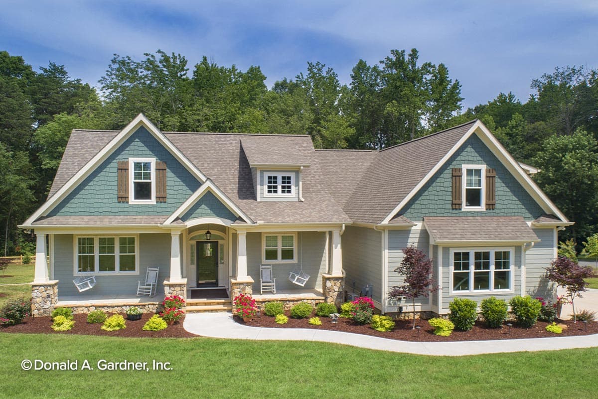 House plan exterior. Ranch-style home with front porch, multiple gables, and dormer window. Two-story home with shake siding on gables.