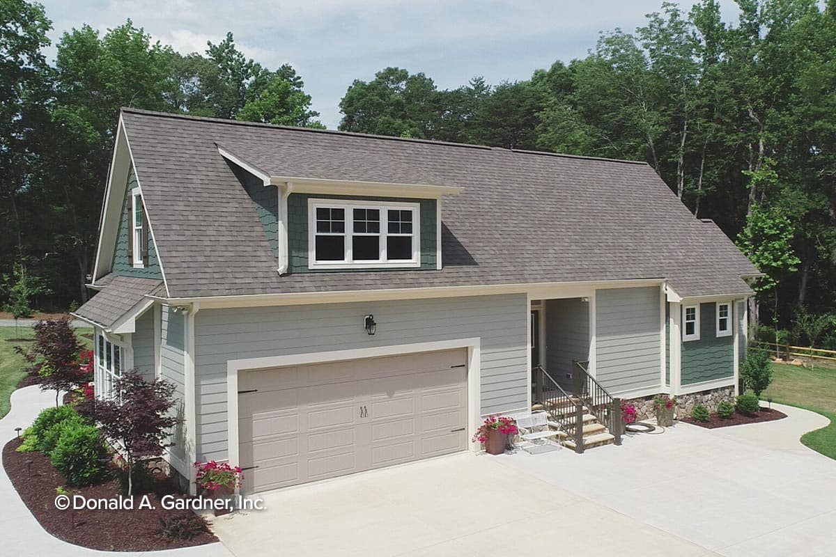 House plan exterior: Two-story Modern Farmhouse with a side-entry garage, dormer, and covered porch.
