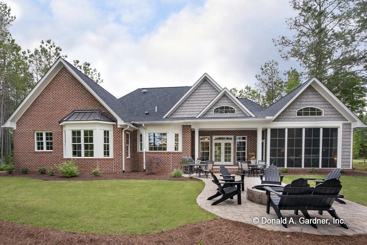 House plan exterior with brick facade, gables, dormers, bay window, and screened porch.