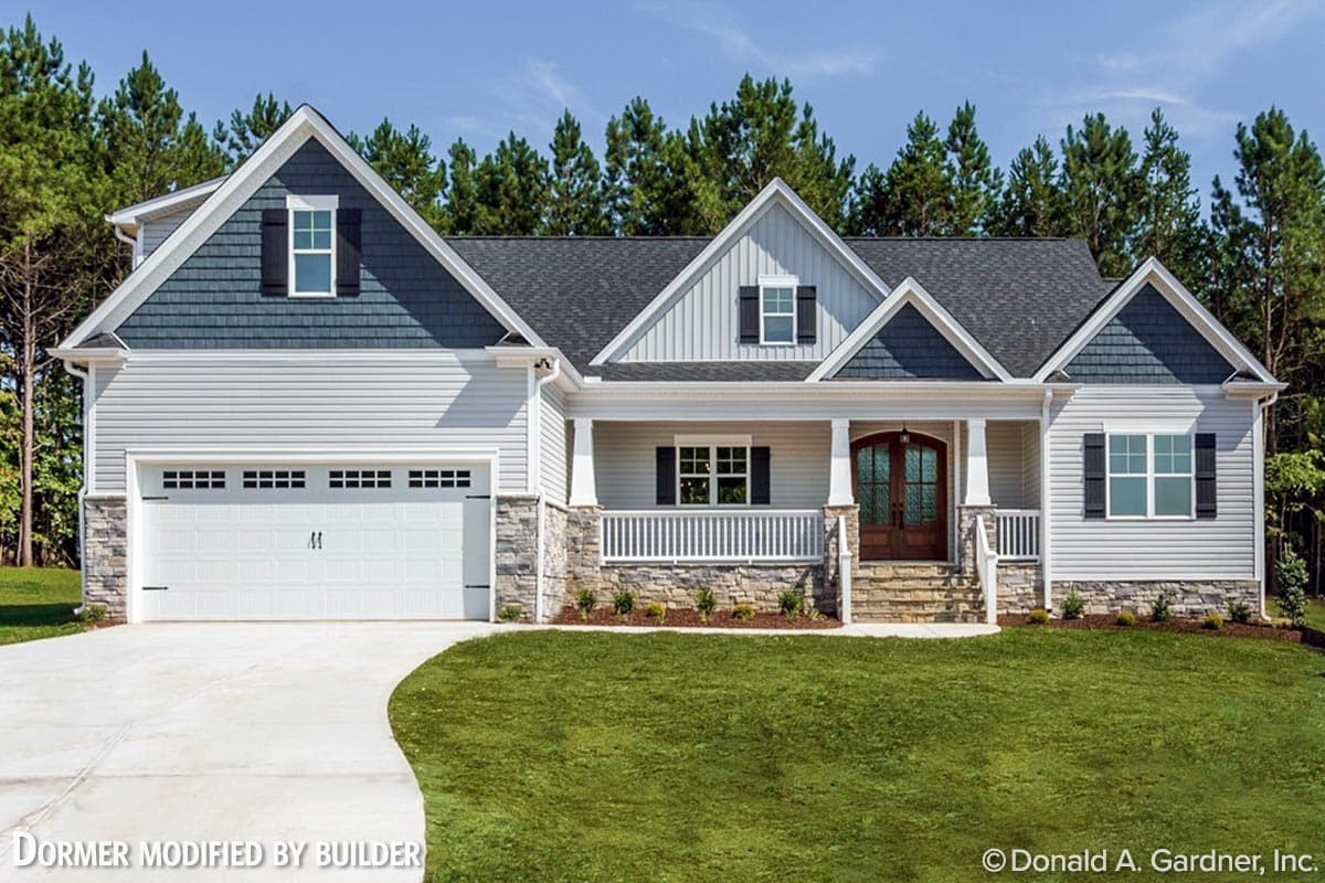 House plan exterior with Craftsman style, featuring a porch, gables, and shake siding accents. Includes a two-car garage with a stone facade.