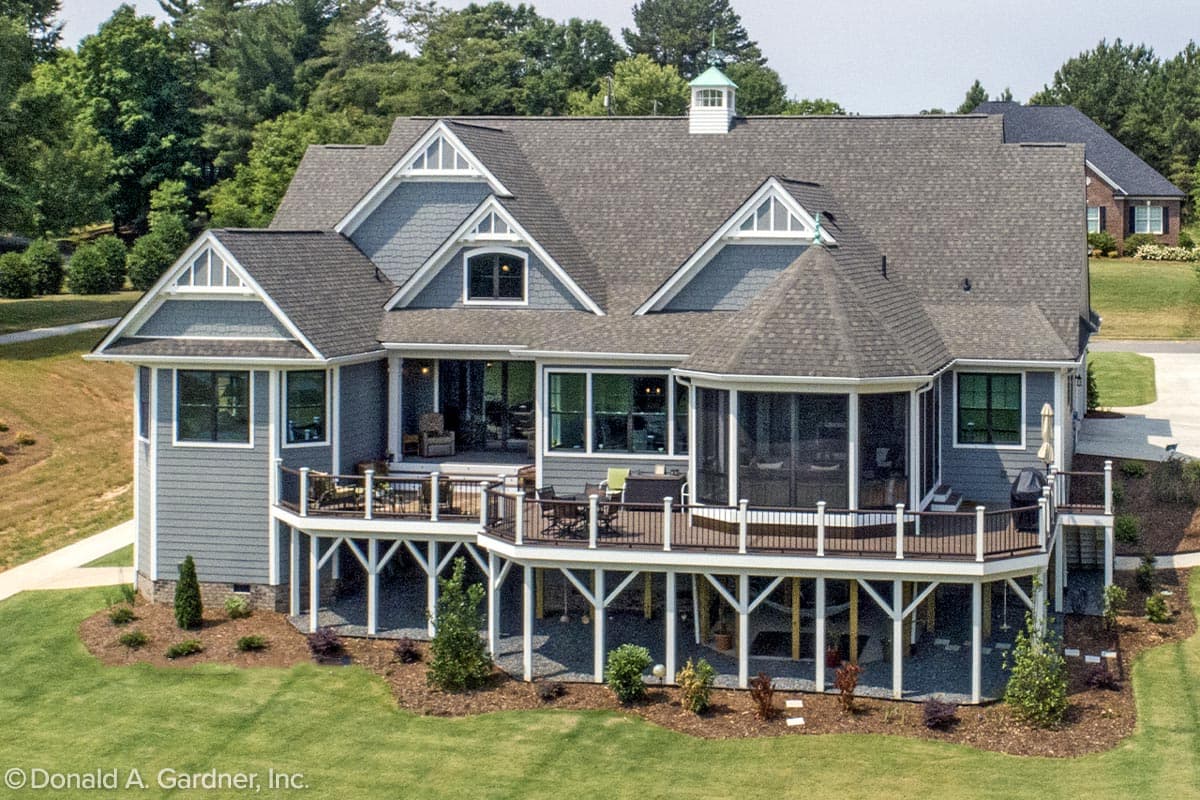 House plan exterior: Two-story home with multiple gables, a cupola, wraparound deck, and screened porch.