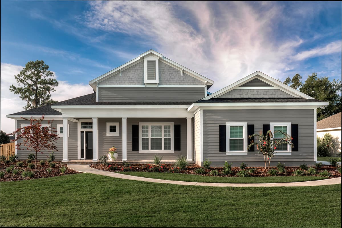 House plan exterior: One-story dwelling with covered front porch supported by columns, gabled rooflines, dormer, and lap siding.