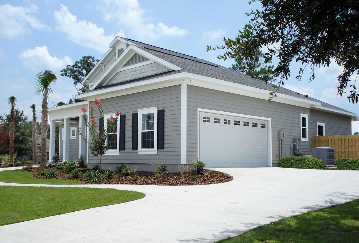 One-story house plan exterior with gabled roof, covered porch, and attached garage.