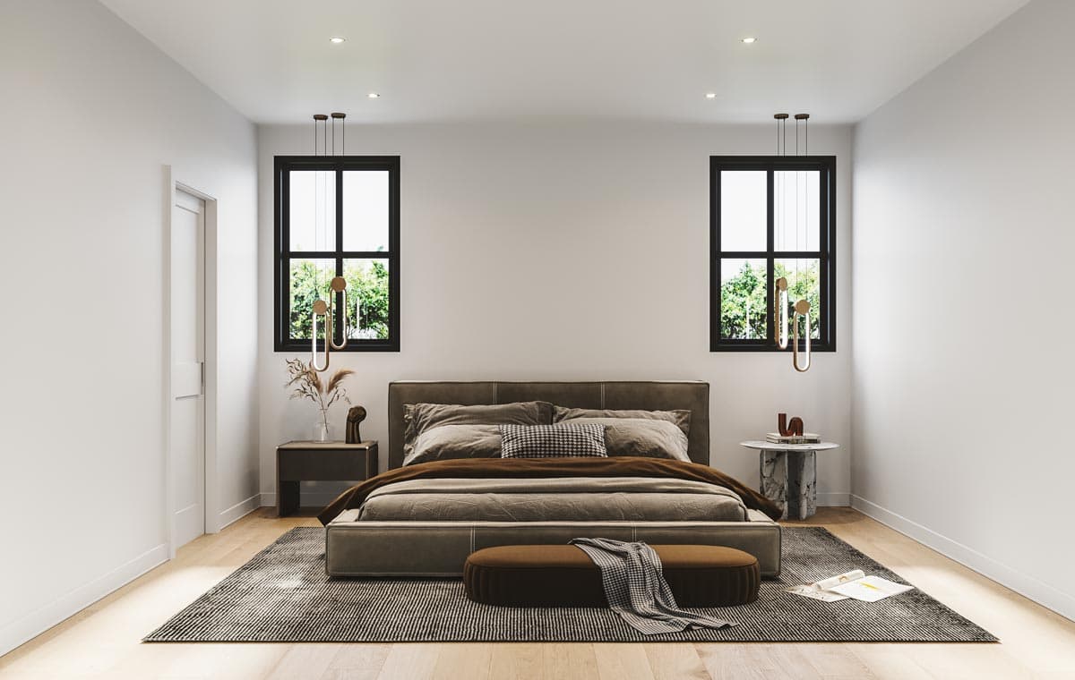 A modern bedroom with a large bed beneath two windows, each with unique pendant lights. A bench and patterned rug add to the sophisticated design.