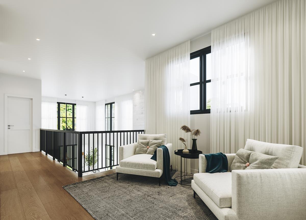 Bright, modern living room with two off-white armchairs, sheer curtains, dark framed windows, and a black wrought iron railing leading to a balcony.