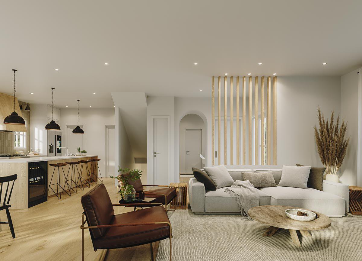 Open concept living space with a kitchen island, seating area, and an arched doorway leading to a staircase.