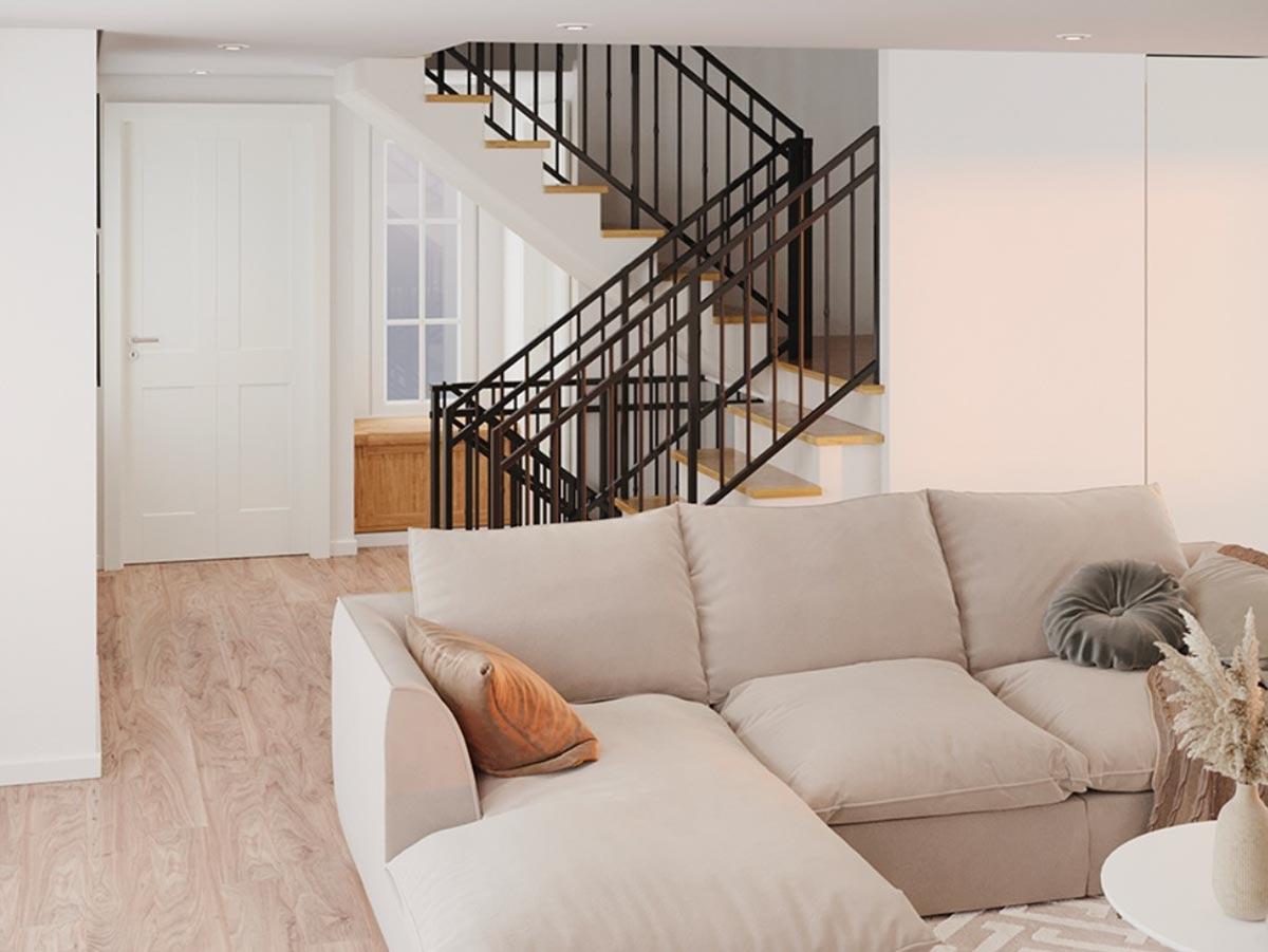 Interior view of house with sectional sofa, wood floor, white paneled door, and open staircase with black railing.