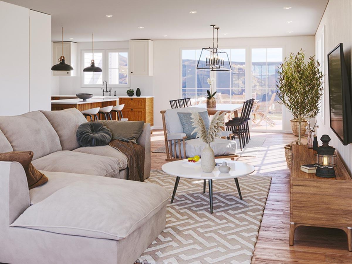 Open-plan living space with sectional sofa, kitchen island, dining area, and large windows overlooking outdoor space.