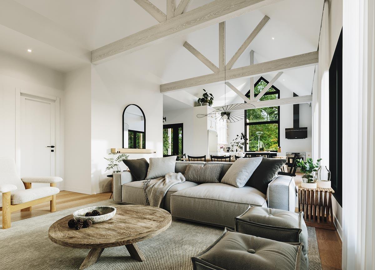 Great room with vaulted ceiling, exposed beams, sectional sofa, coffee table, and open view to kitchen and dining area.