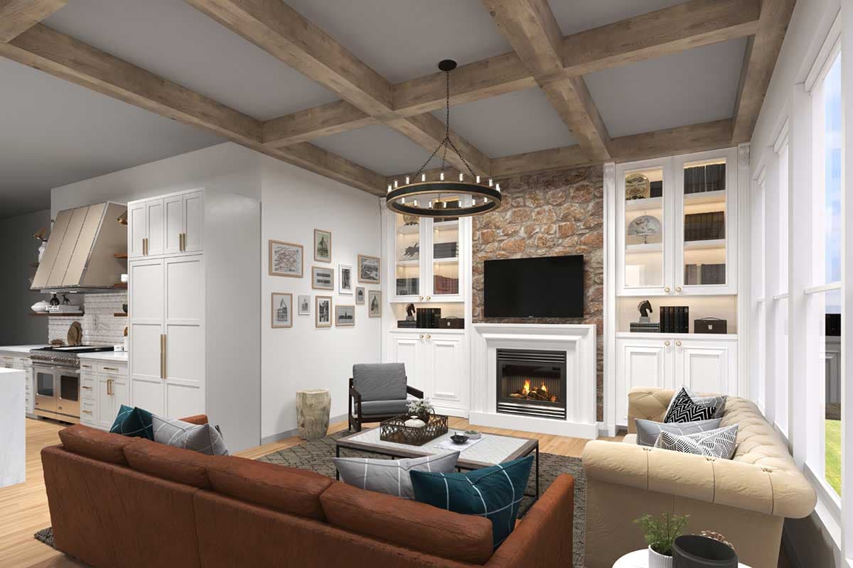Open living space with coffered wood beam ceiling, stone fireplace, built-in shelving, and kitchen view.