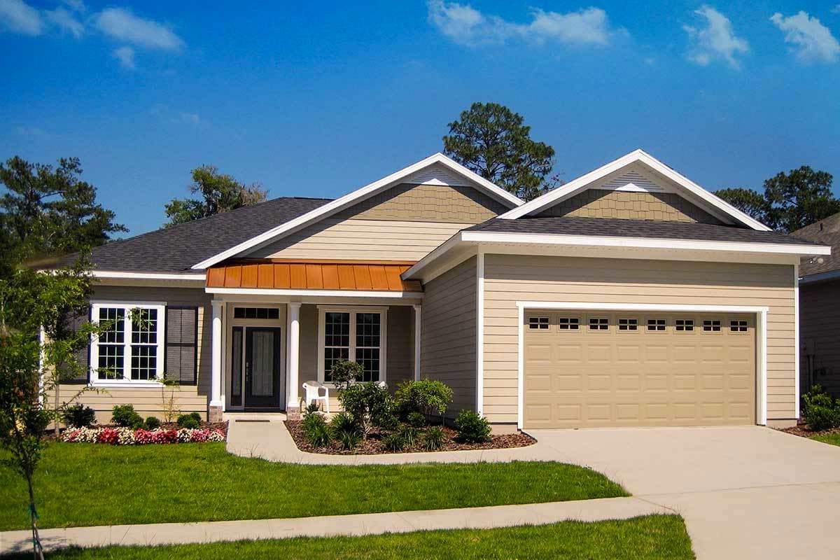 Ranch style house plan exterior with two stories, covered front porch, gable detailing, and attached two-car garage.