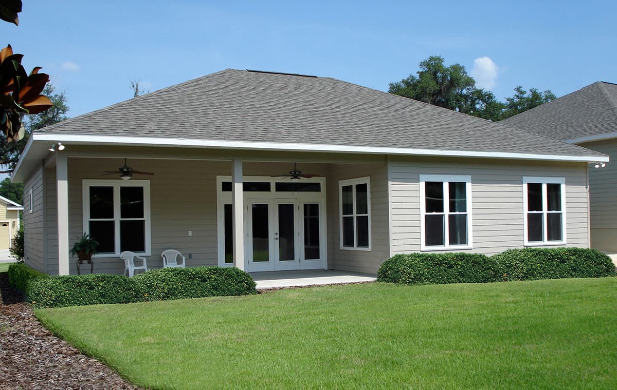 House plan exterior: single-story Ranch with covered porch, double doors, and multiple windows.