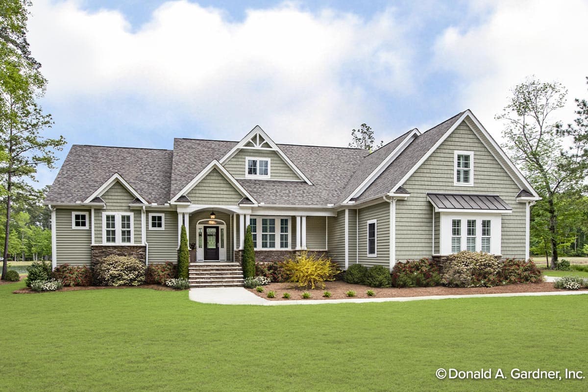 House plan exterior: Ranch style, one story, with a covered entry porch, gables, dormers, and stone foundation accents.