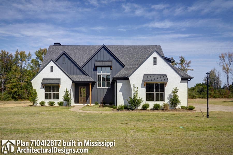 House plan exterior: Modern Farmhouse, two stories, white brick with dark vertical siding, gables, and awnings.