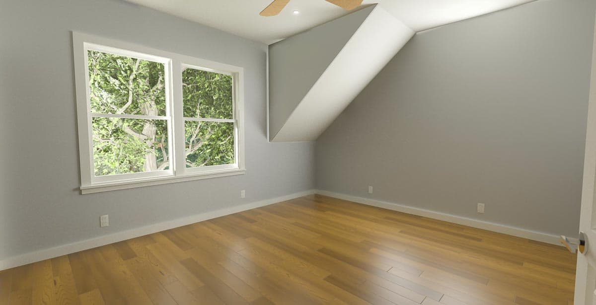 Interior view of an empty room with sloped ceilings, wood floors, and a double-hung window. A ceiling fan is visible.