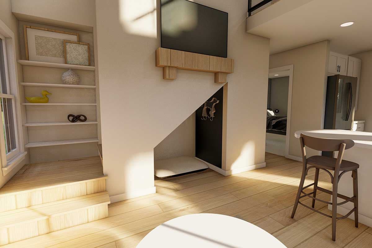 Interior view showing a built-in dog nook under stairs, open shelving, and a television above.