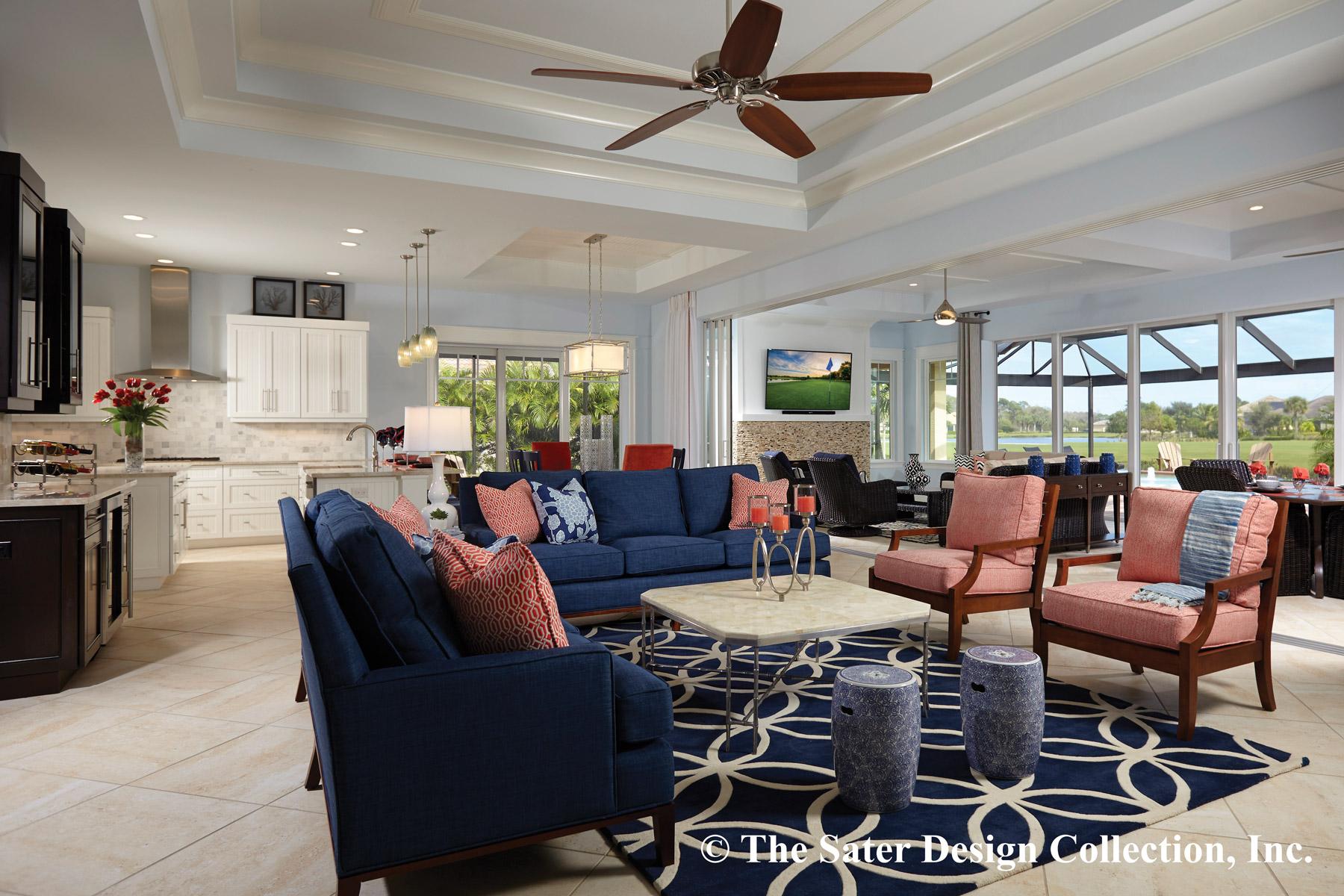 Open-concept living room and kitchen with coffered ceiling, large windows, and a blue sectional sofa.