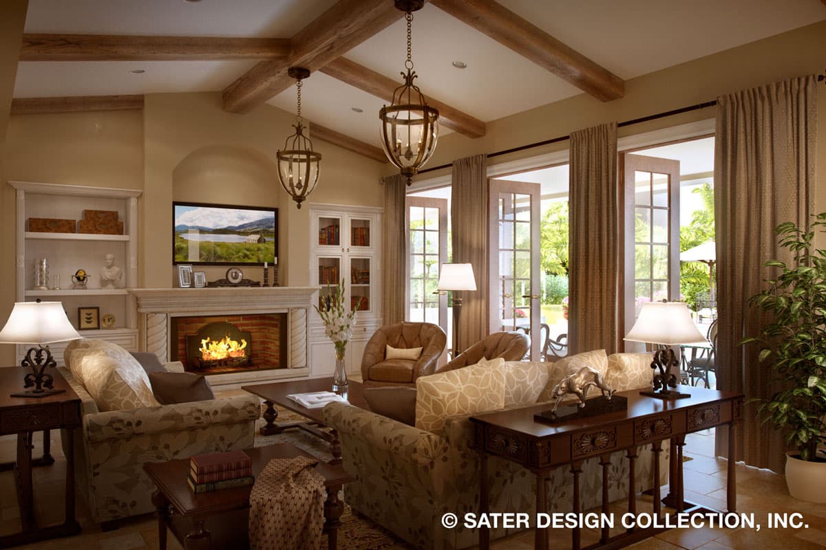 Living room with fireplace, built-in shelving, vaulted ceiling with exposed beams, and French doors opening to an outdoor patio.