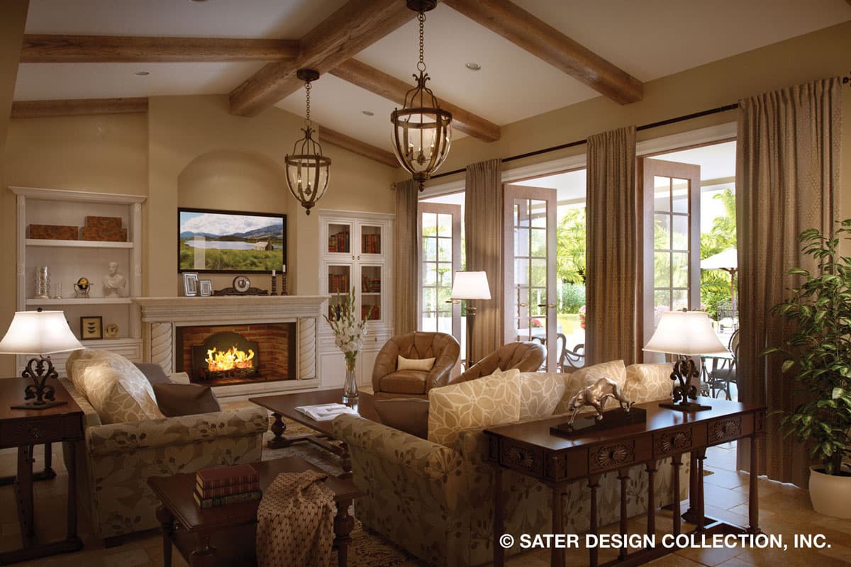 Living room interior with fireplace, exposed beams, and French doors opening to a patio.