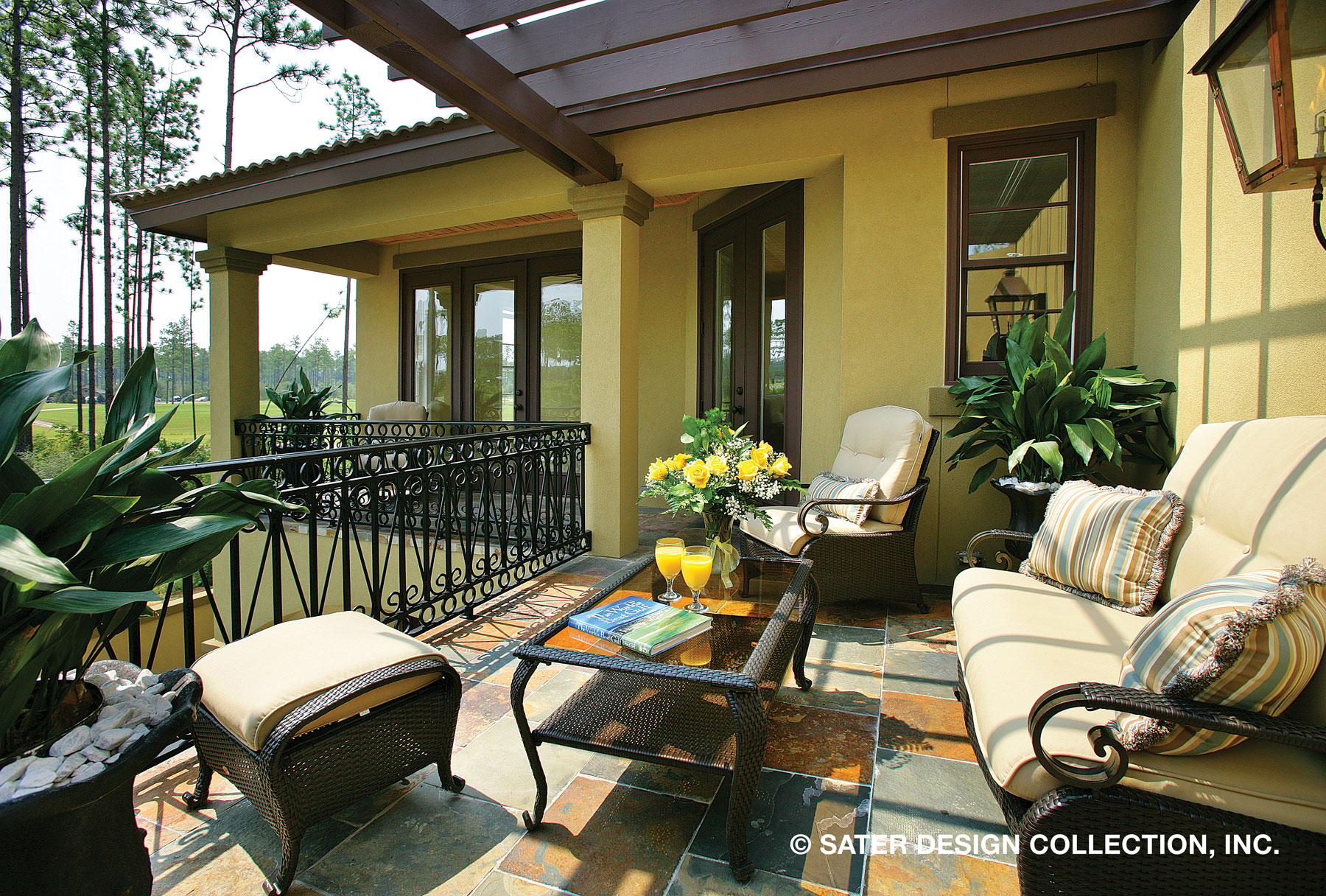 Covered patio with pergola, ornate railings, and seating area.